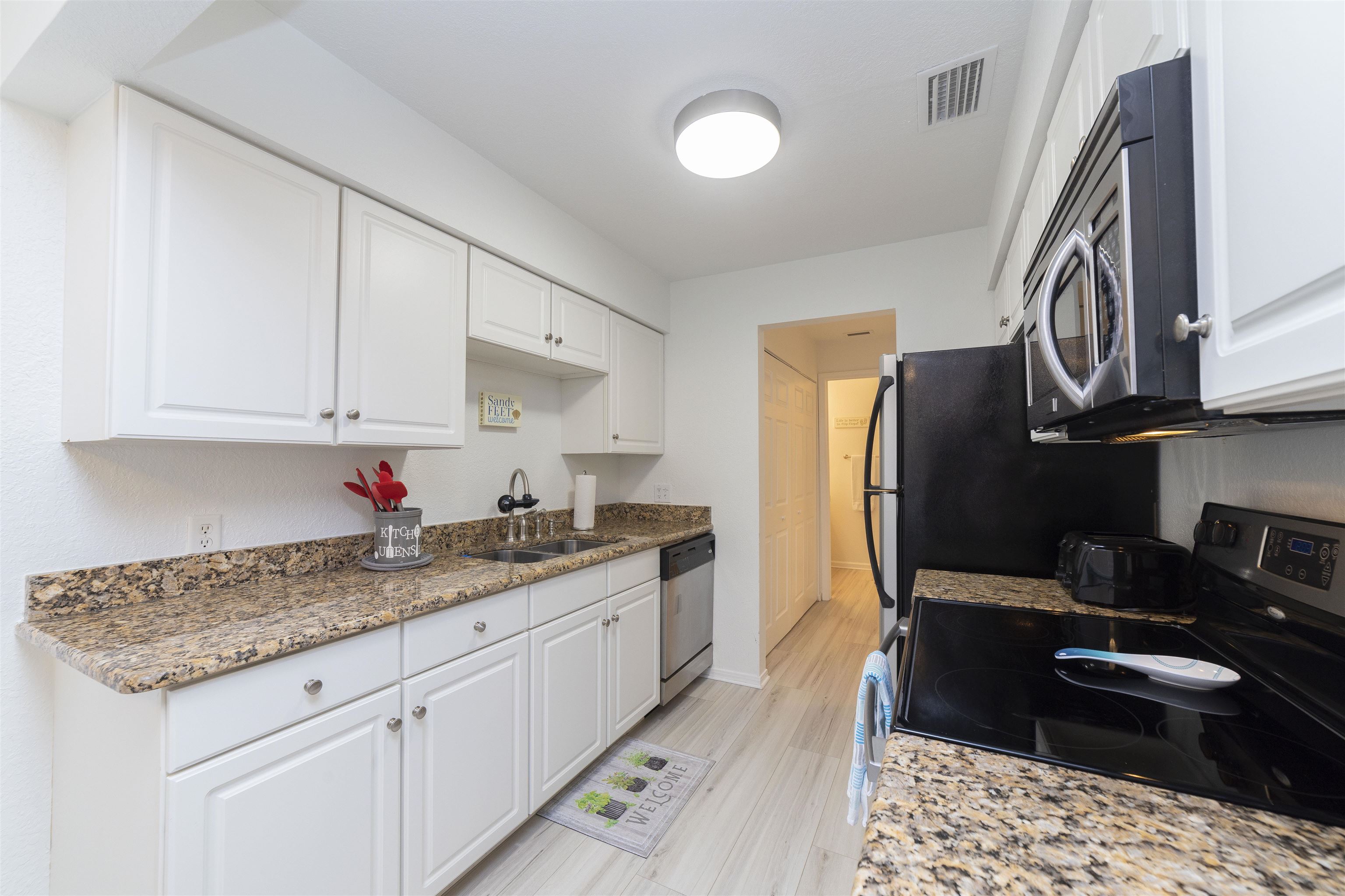 28 Schooner Court, Unit 28 St. Augustine, FL 32080 - Photo 11 of 28 a kitchen with granite countertop a sink stainless steel appliances and cabinets