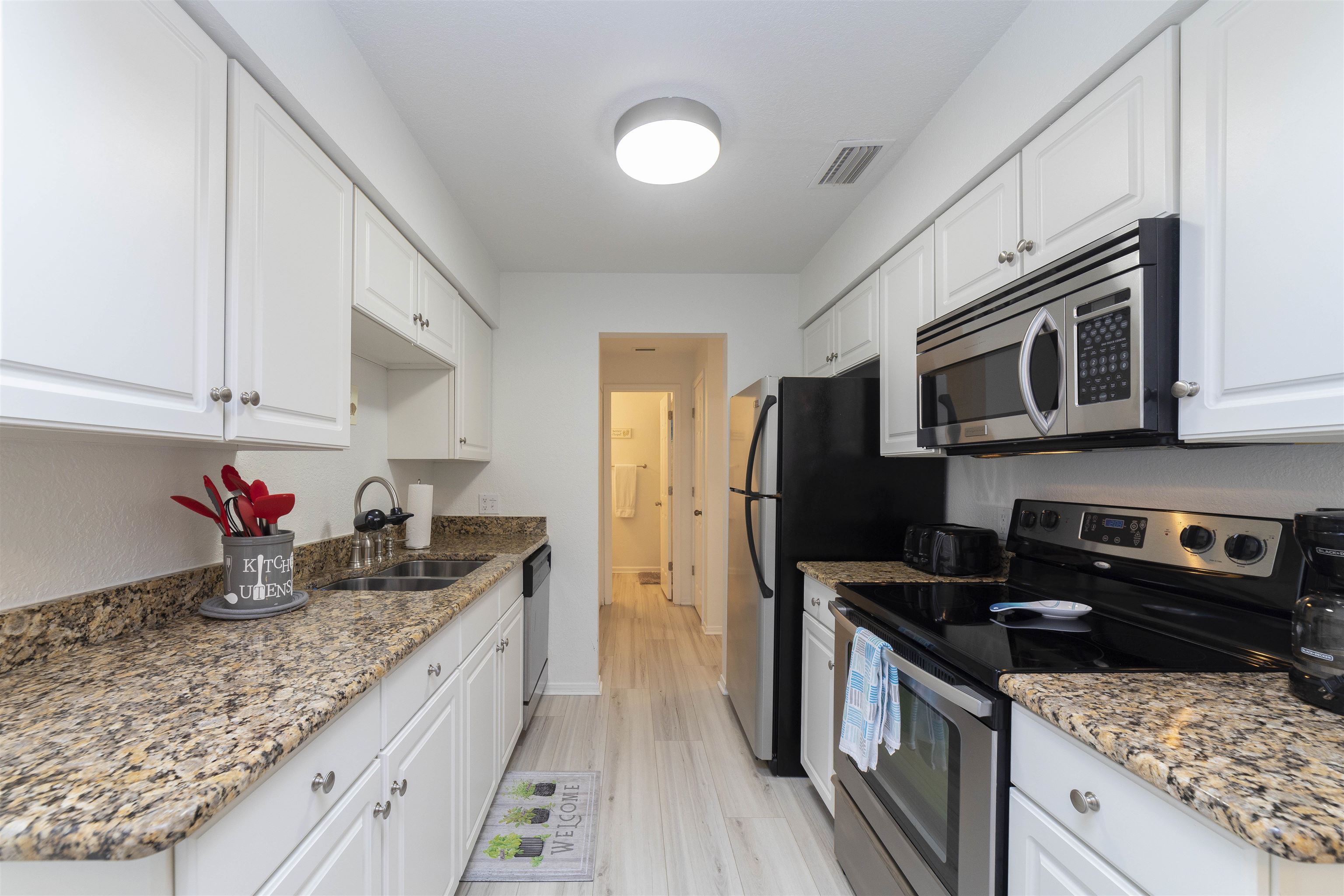 28 Schooner Court, Unit 28 St. Augustine, FL 32080 - Photo 12 of 28 a kitchen with stainless steel appliances granite countertop a sink stove and refrigerator
