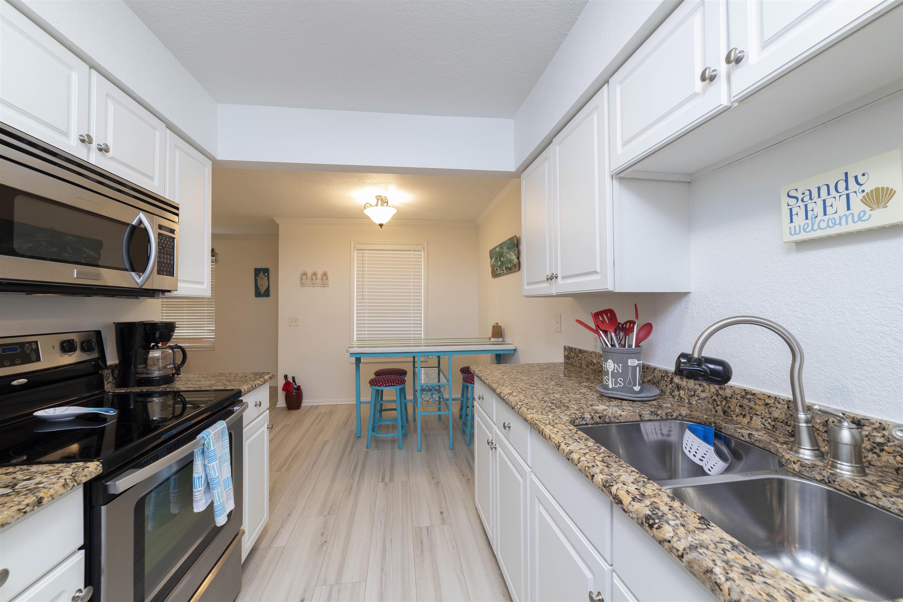 28 Schooner Court, Unit 28 St. Augustine, FL 32080 - Photo 14 of 28 a kitchen with sink a stove and cabinets