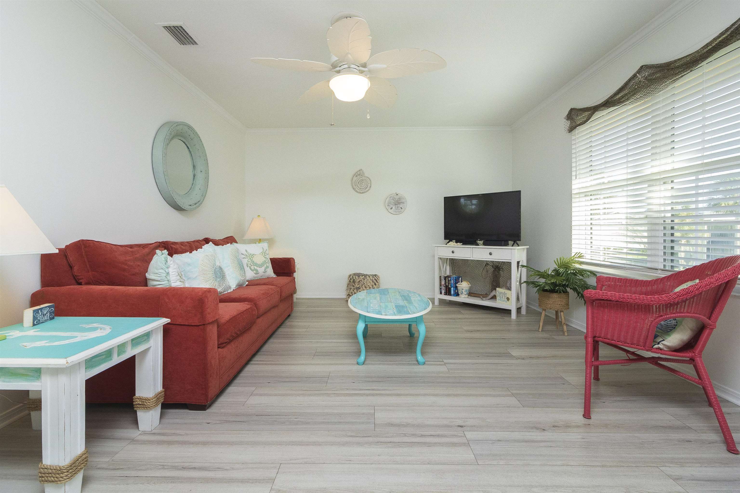 28 Schooner Court, Unit 28 St. Augustine, FL 32080 - Photo 4 of 28 a living room with furniture a flat screen tv and a window