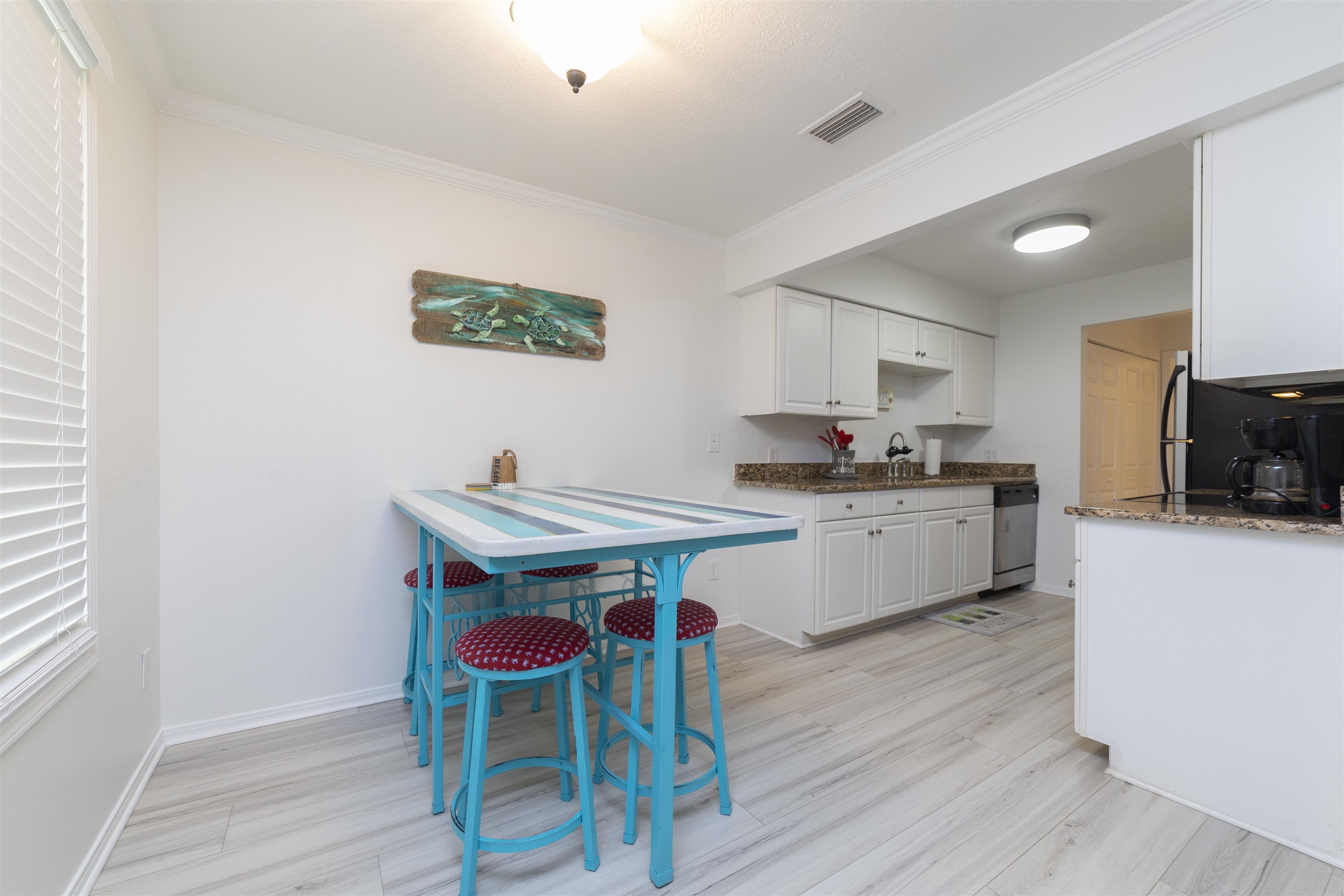 28 Schooner Court, Unit 28 St. Augustine, FL 32080 - Photo 10 of 28 a kitchen with stainless steel appliances a stove a sink dishwasher and a refrigerator with wooden floor