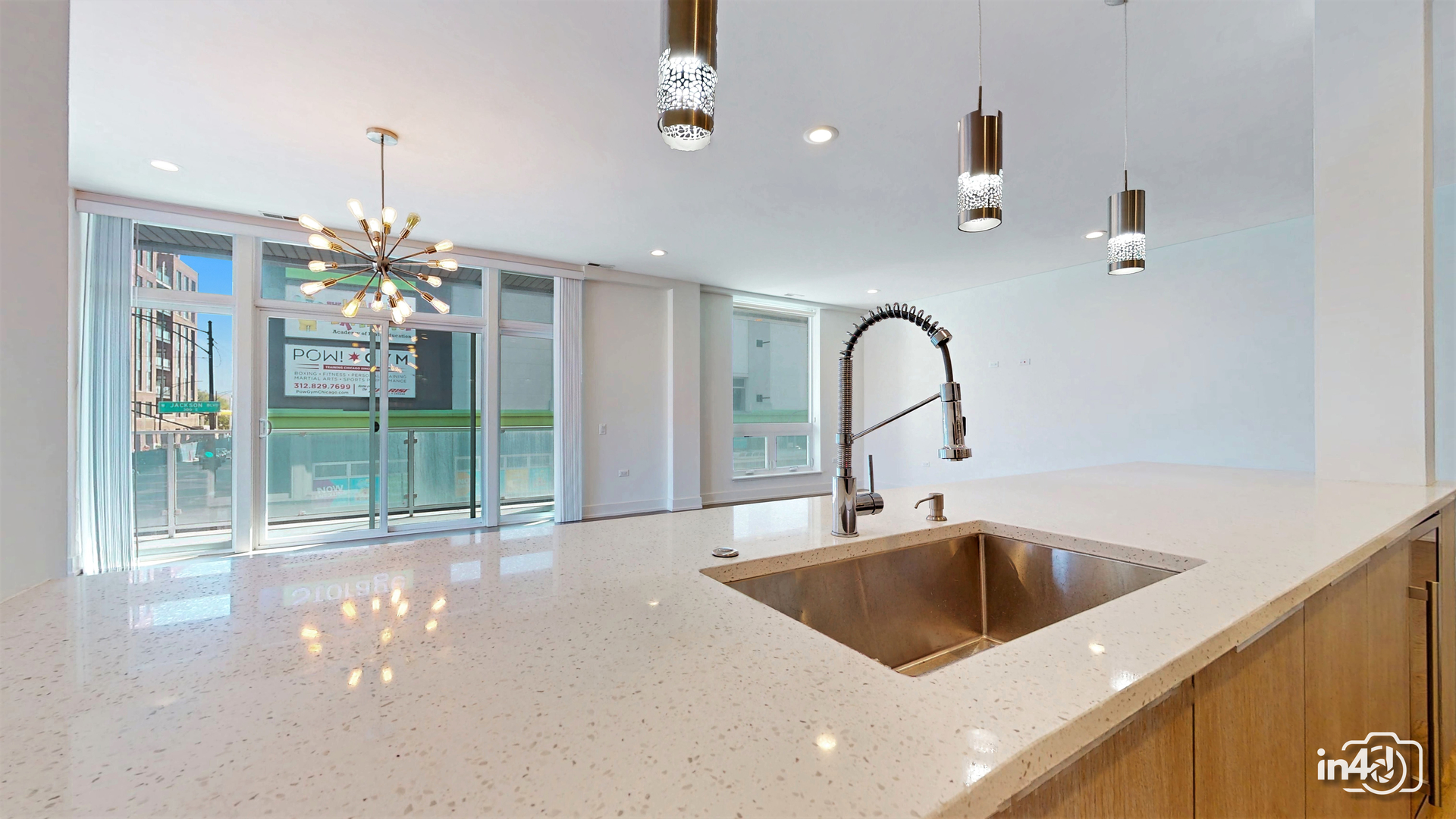 236 South Racine Avenue, Unit 201 Chicago, IL 60607 - Photo 17 of 45 a kitchen with a faucet a chandelier and living room view