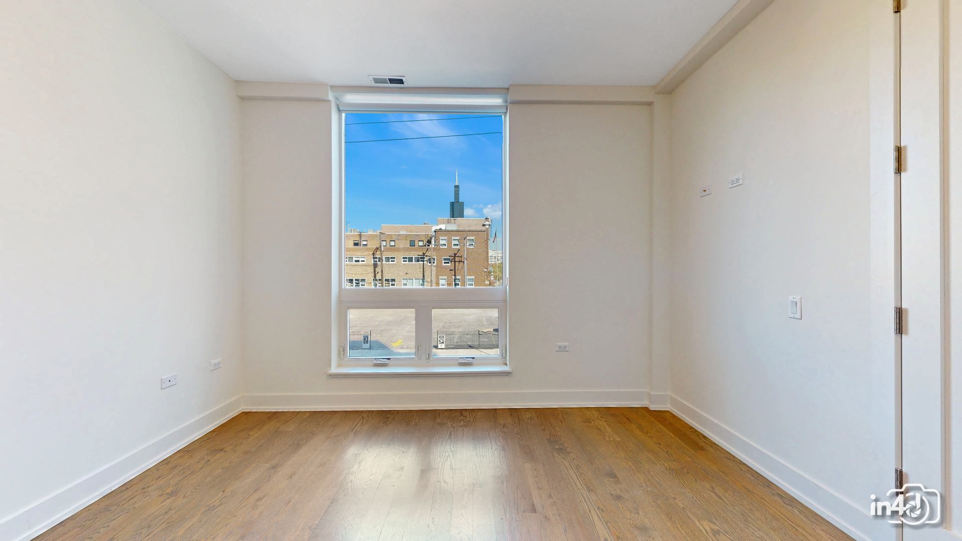 236 South Racine Avenue, Unit 201 Chicago, IL 60607 - Photo 27 of 45 a view of a small space with wooden floor and a window