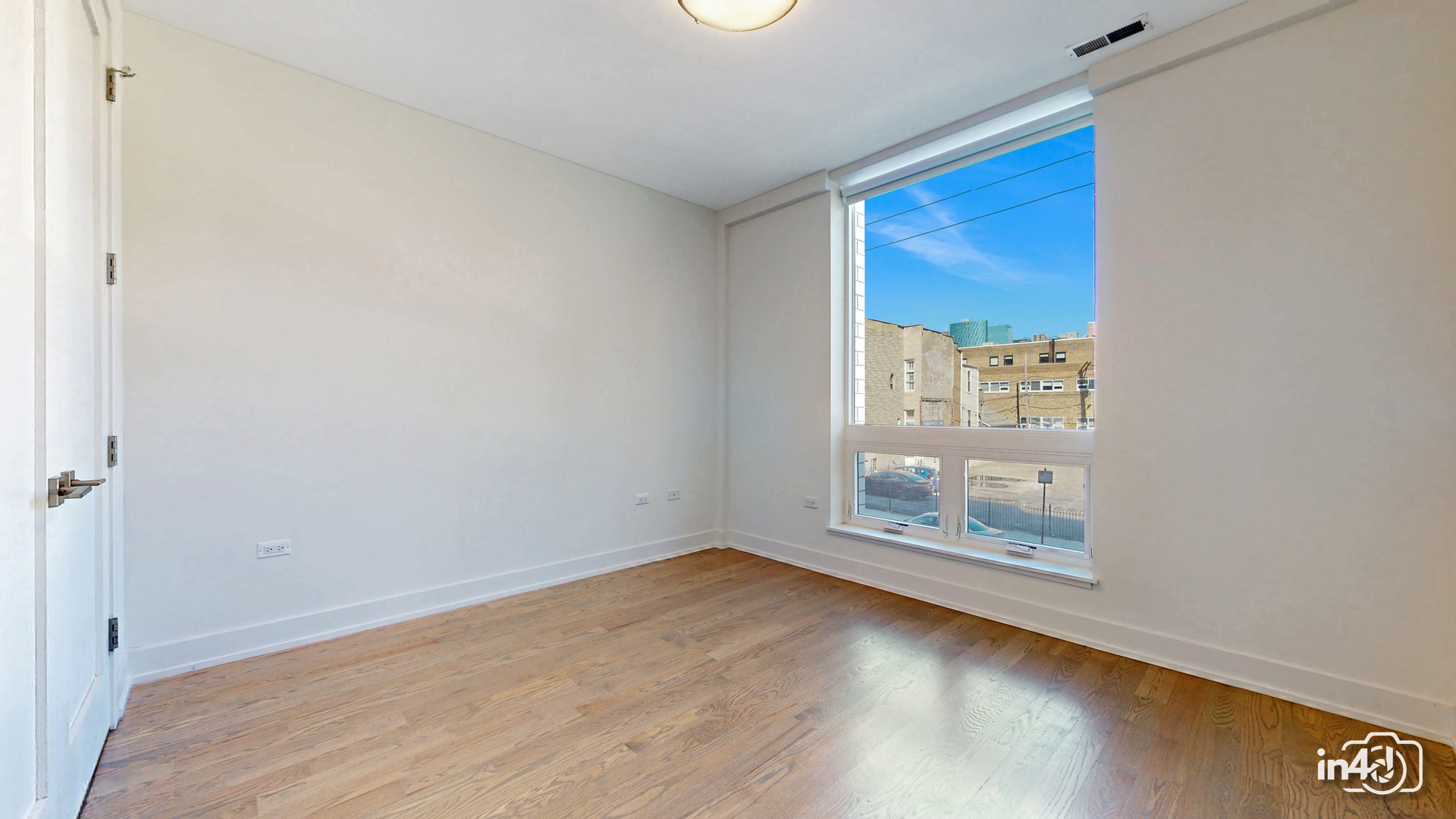 236 South Racine Avenue, Unit 201 Chicago, IL 60607 - Photo 33 of 45 an empty room with wooden floor and door