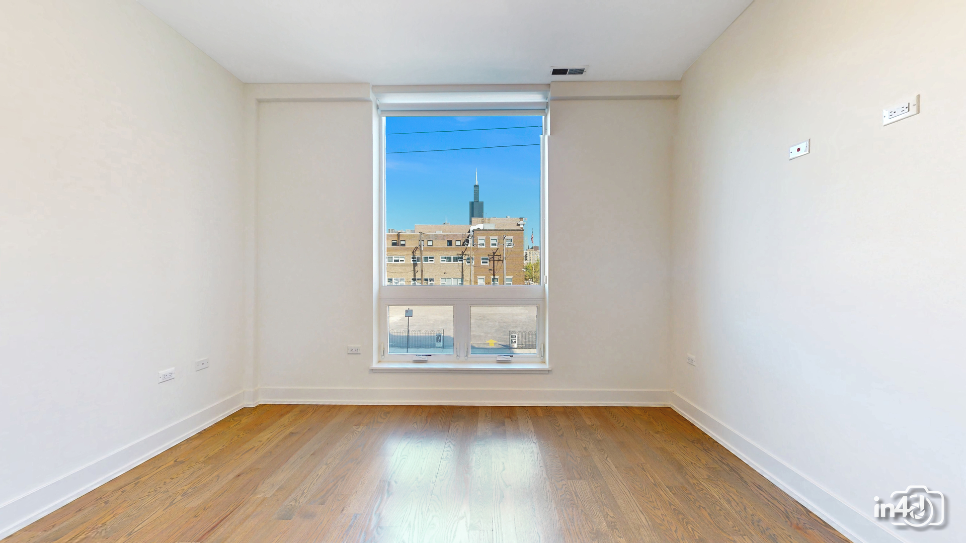 236 South Racine Avenue, Unit 201 Chicago, IL 60607 - Photo 34 of 45 an empty room with wooden floor and windows