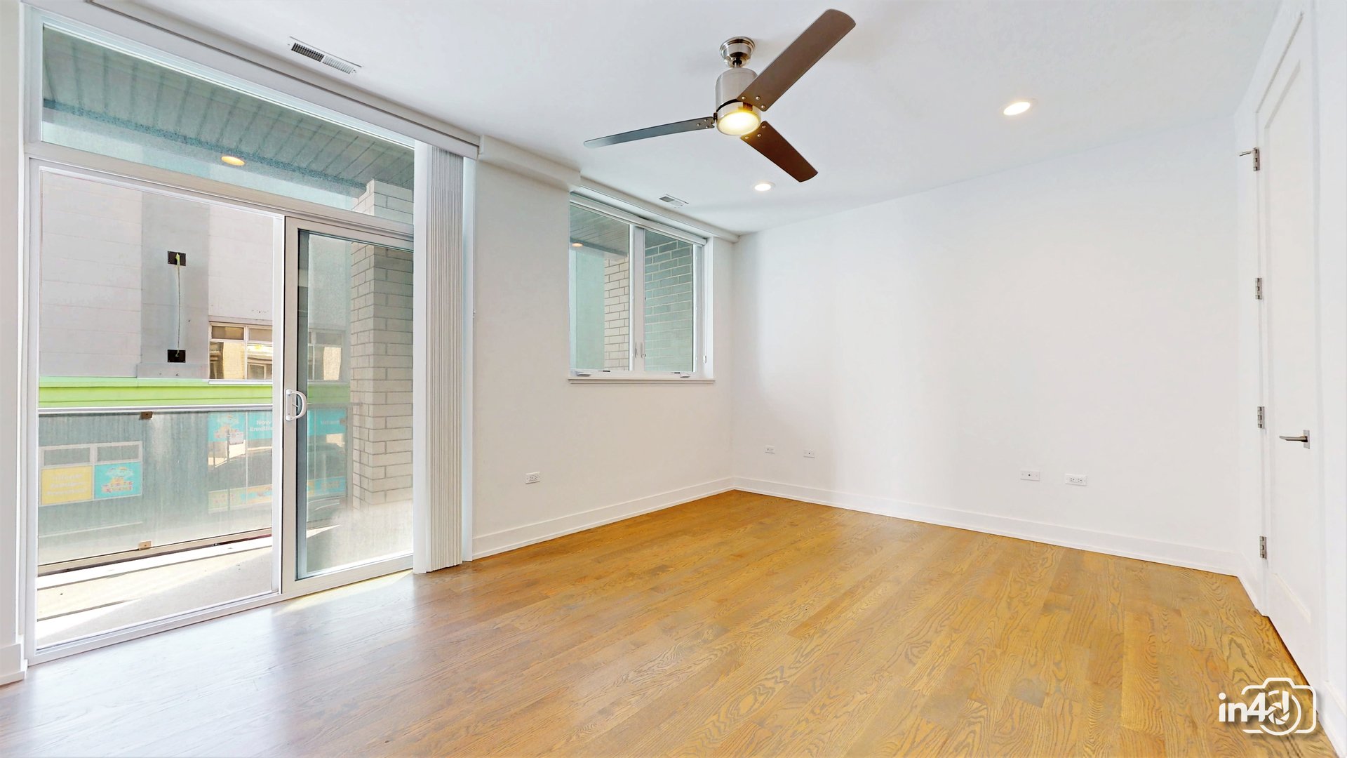 236 South Racine Avenue, Unit 201 Chicago, IL 60607 - Photo 36 of 45 a view of empty room with wooden floor and fan