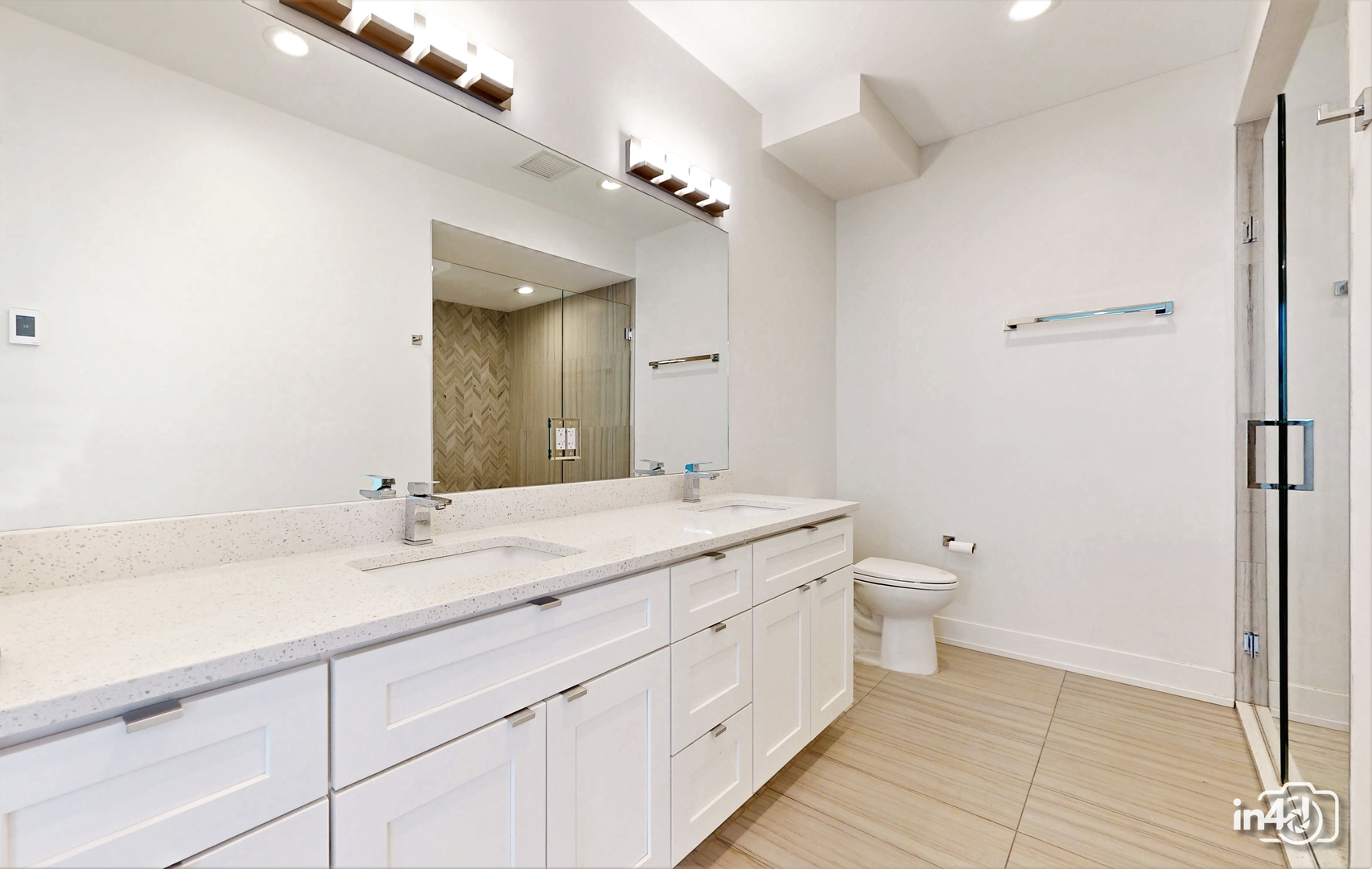 236 South Racine Avenue, Unit 201 Chicago, IL 60607 - Photo 39 of 45 a bathroom with a granite countertop sink a toilet and a mirror