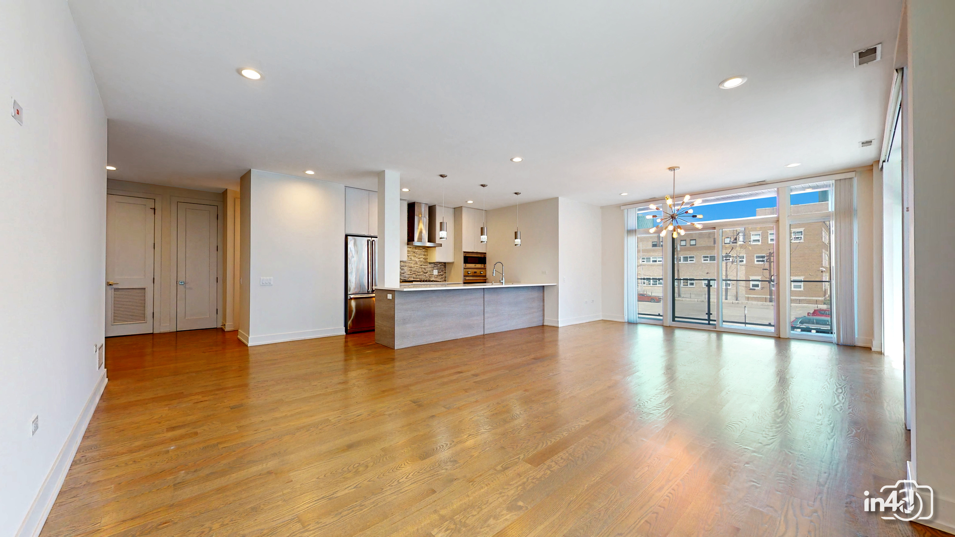 236 South Racine Avenue, Unit 201 Chicago, IL 60607 - Photo 8 of 45 a view of empty room with wooden floor and windows