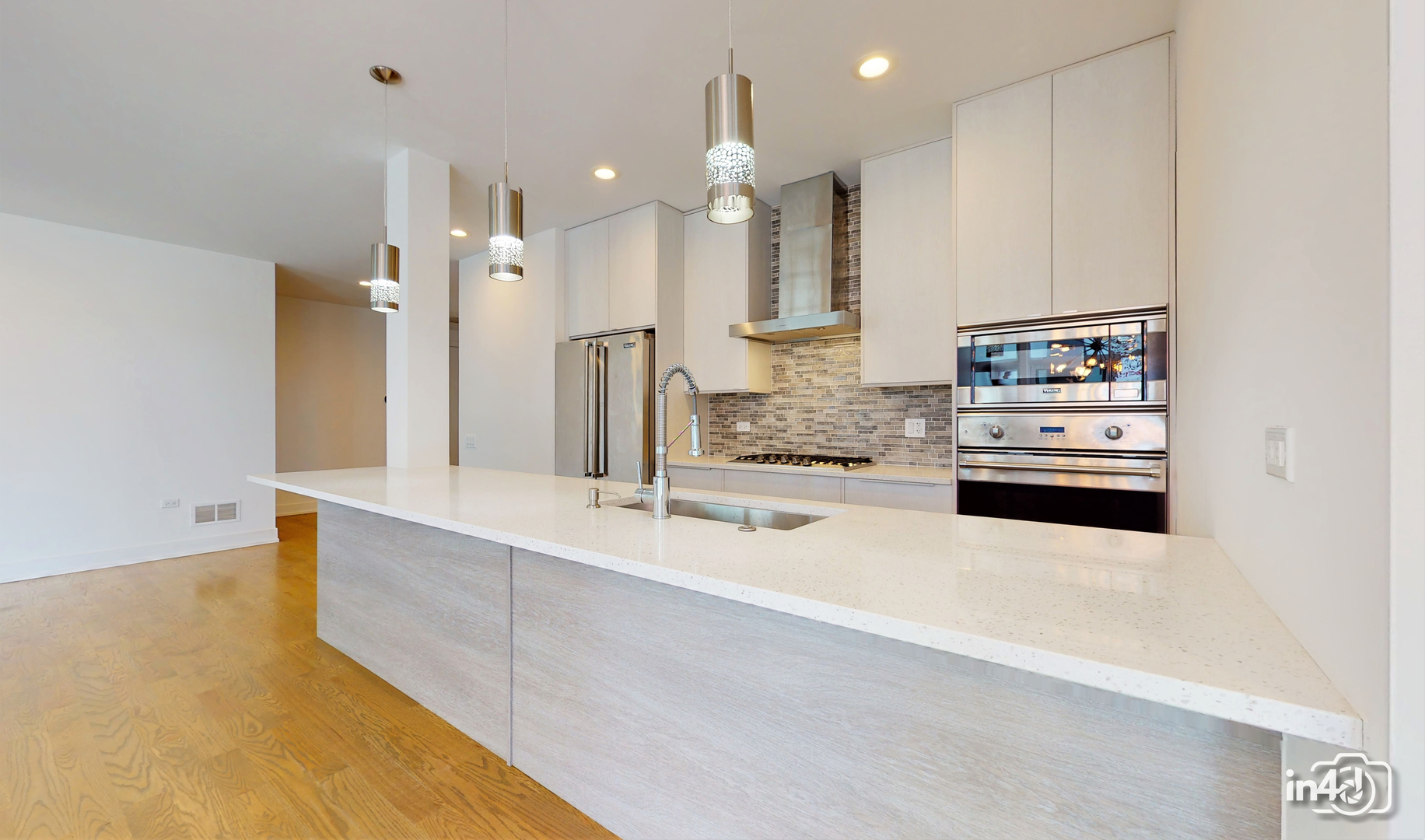 236 South Racine Avenue, Unit 201 Chicago, IL 60607 - Photo 9 of 45 a large kitchen with kitchen island a sink stainless steel appliances and cabinets