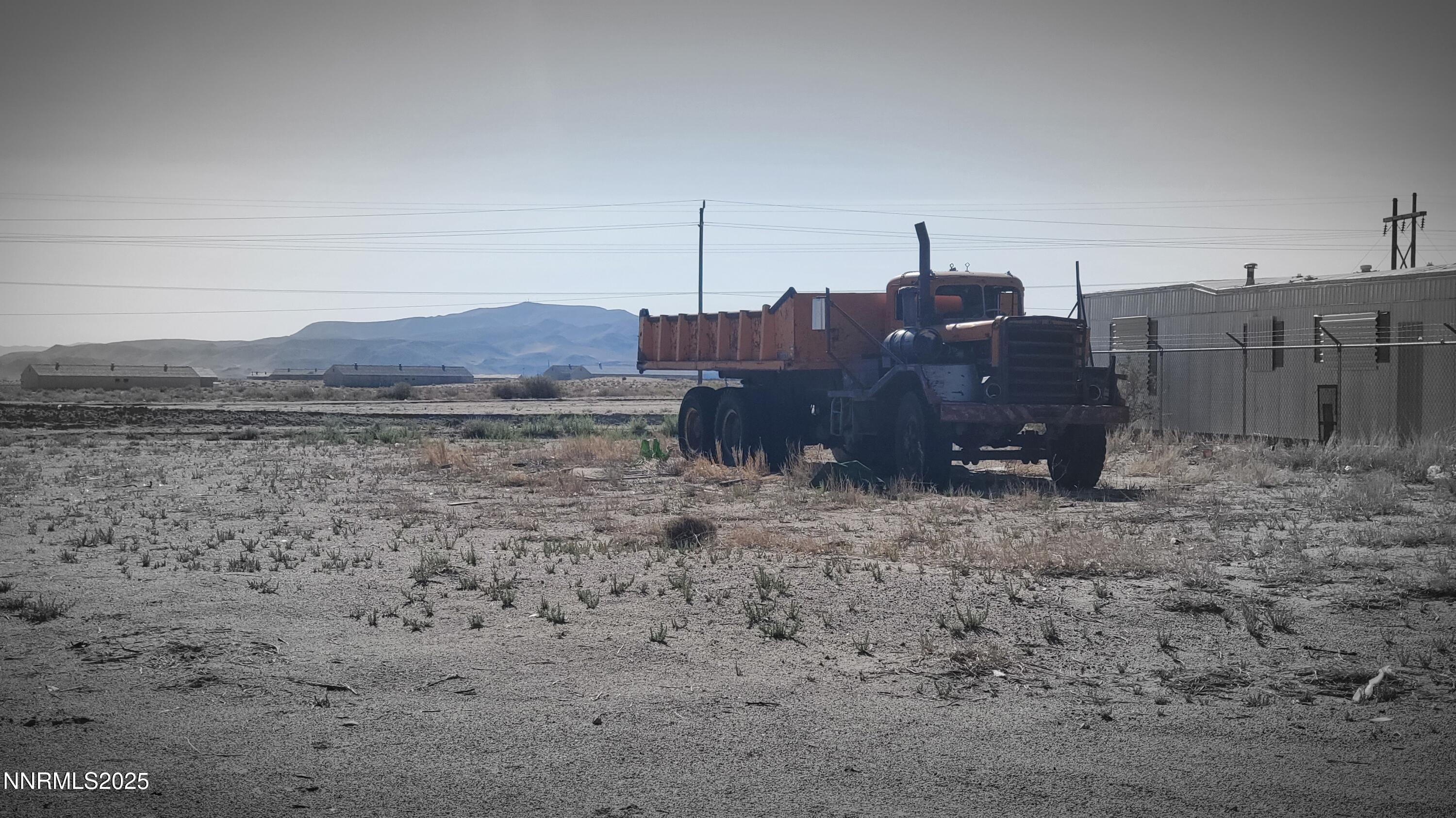 a view of a dry yard with a barn