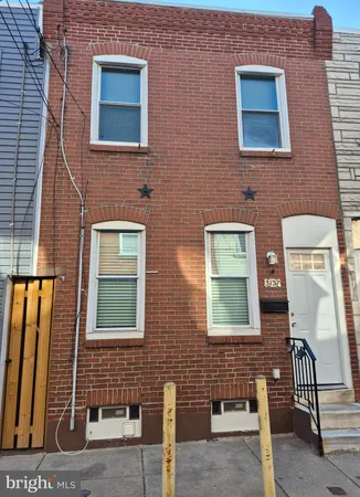 a brick building with four windows