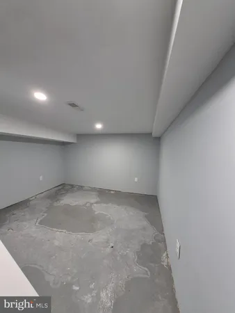 a view of empty room with wooden ceiling