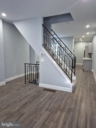 a view of staircase with wooden floor and a rug