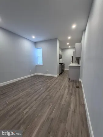 a view of a room with wooden floor