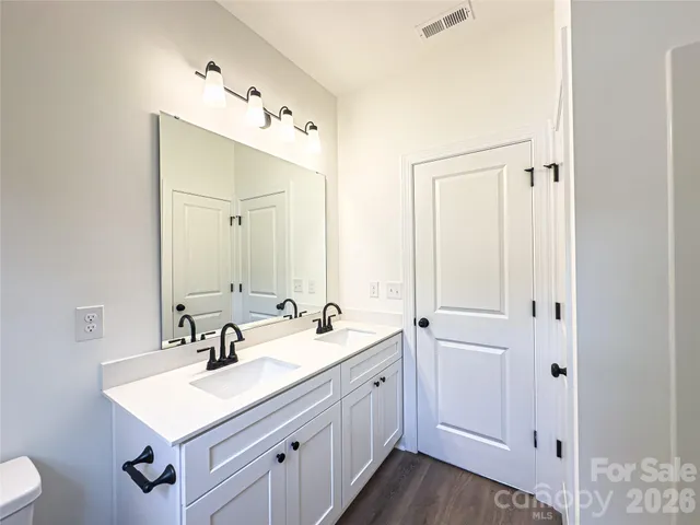 a bathroom with a sink vanity and a mirror
