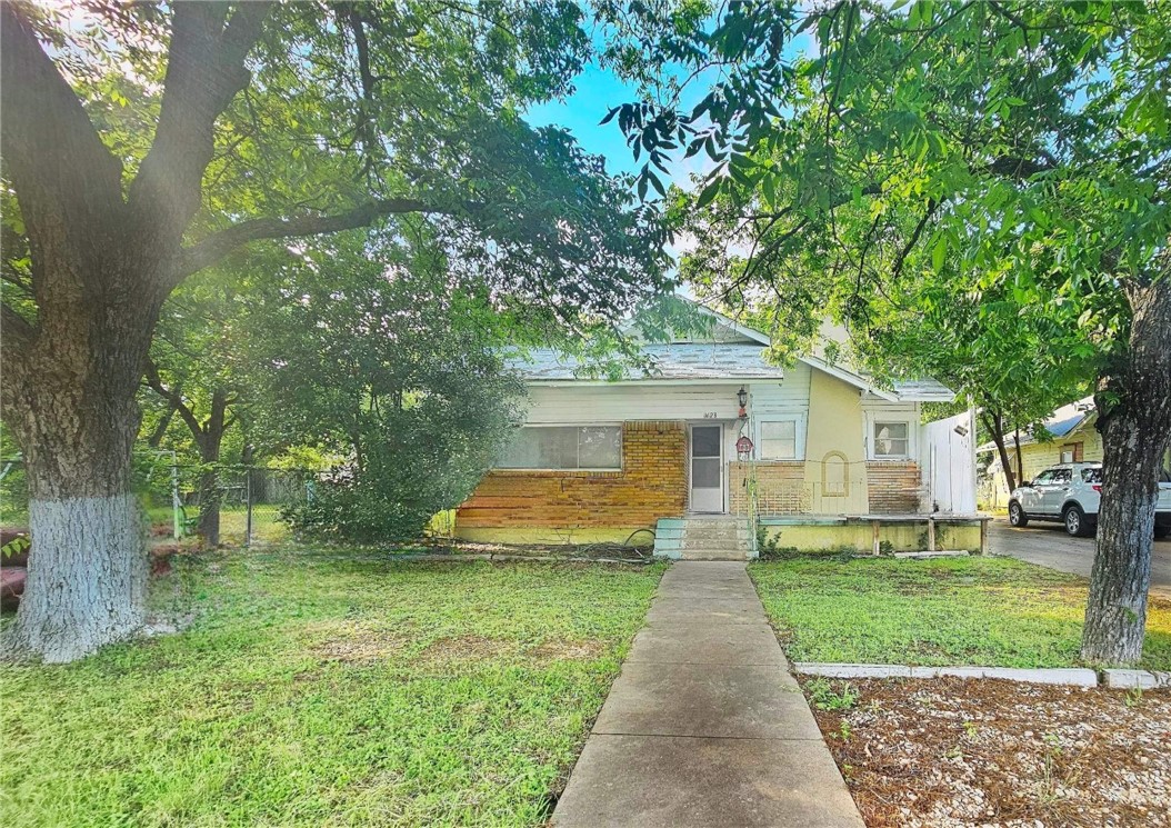 a front view of house with yard and green space