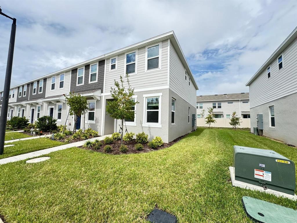 3140 Skyline Loop Kissimmee, FL 34758 - Photo 1 of 27 a front view of a house with garden