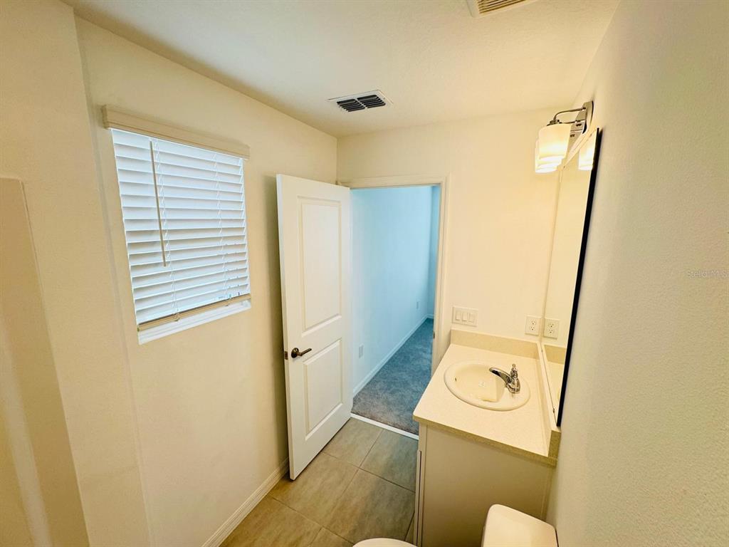 3140 Skyline Loop Kissimmee, FL 34758 - Photo 11 of 27 a bathroom with a sink and mirror