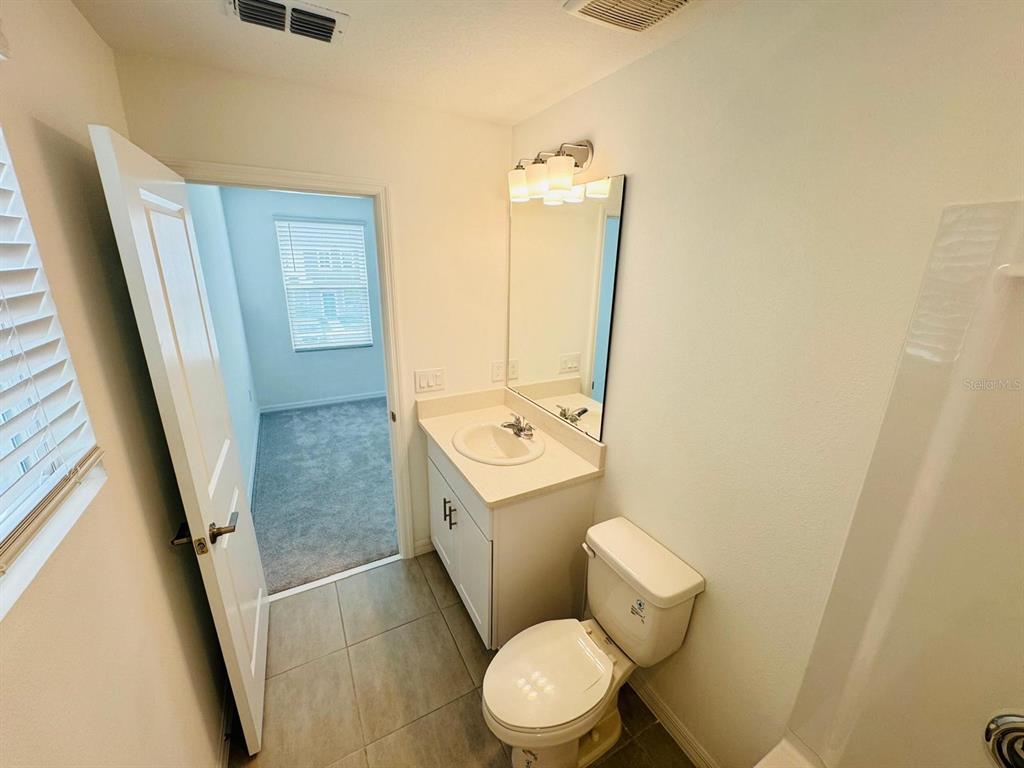 3140 Skyline Loop Kissimmee, FL 34758 - Photo 13 of 27 a white toilet sitting next to a sink