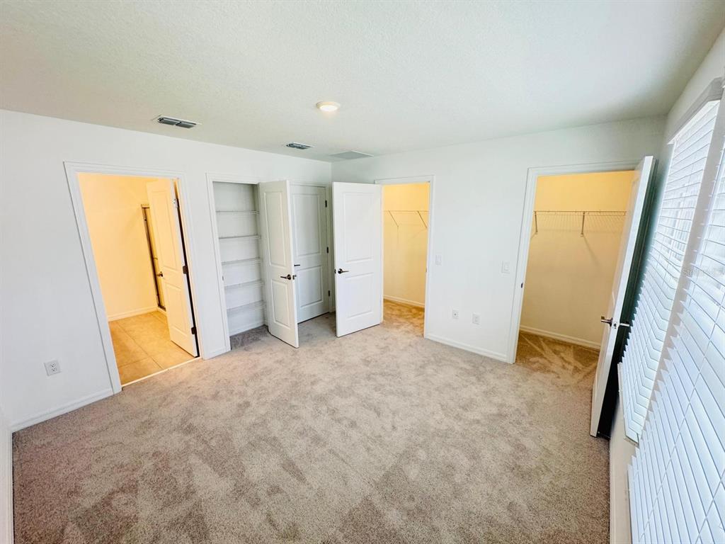 3140 Skyline Loop Kissimmee, FL 34758 - Photo 14 of 27 a view of empty room with closet and wooden floor