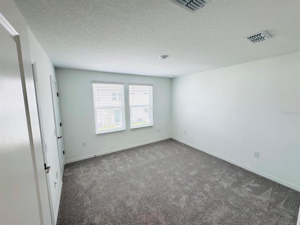 3140 Skyline Loop Kissimmee, FL 34758 - Photo 15 of 27 an empty room with windows