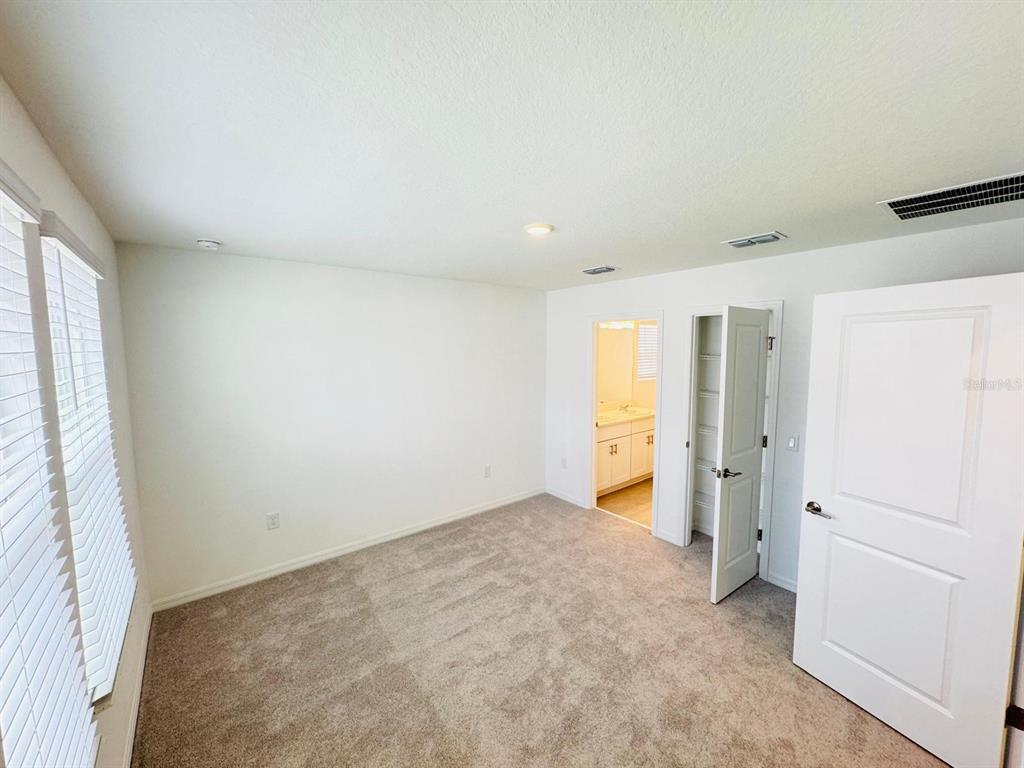 3140 Skyline Loop Kissimmee, FL 34758 - Photo 16 of 27 an empty room with a natural light