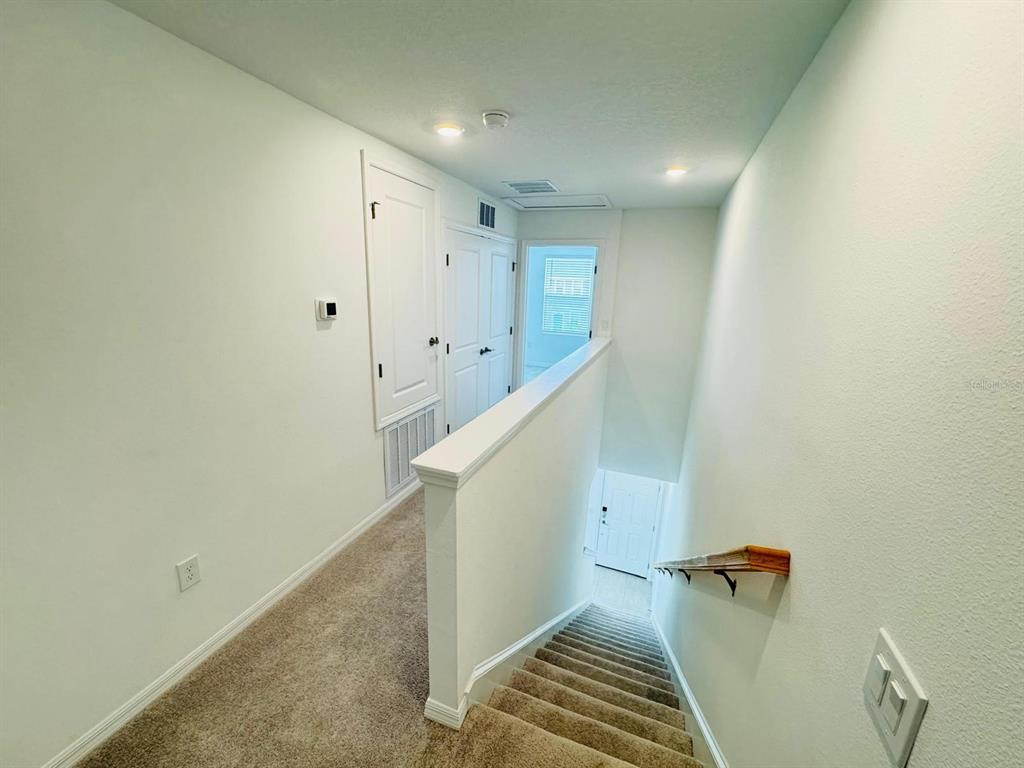 3140 Skyline Loop Kissimmee, FL 34758 - Photo 17 of 27 a view of a hallway with stairs