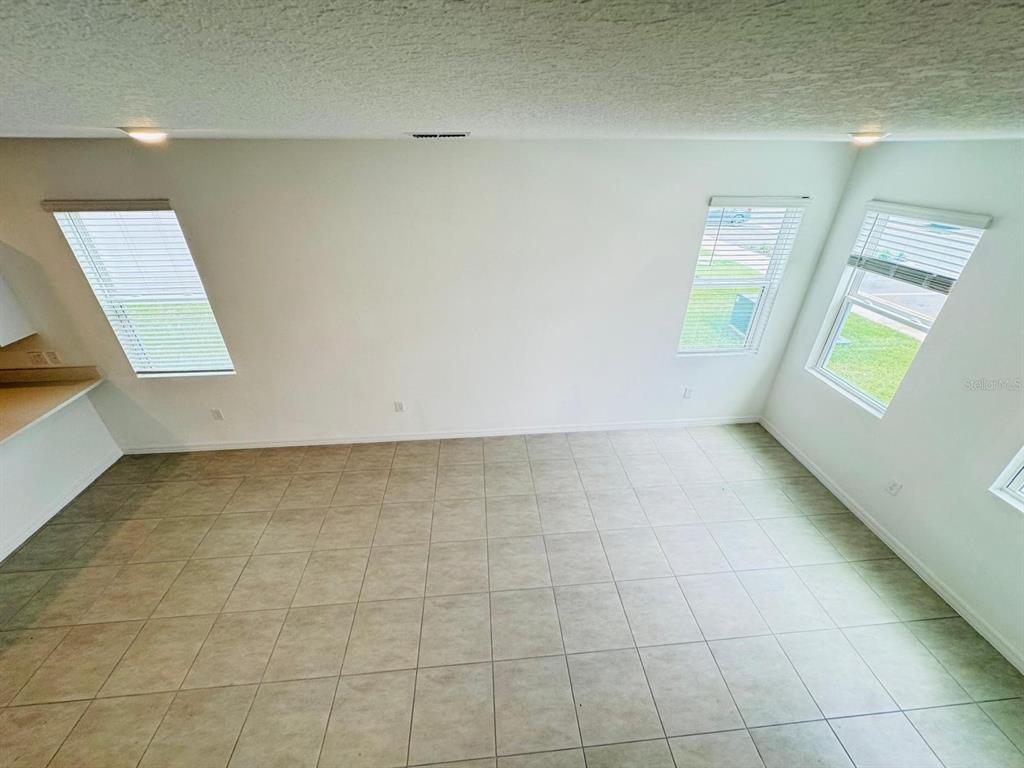 3140 Skyline Loop Kissimmee, FL 34758 - Photo 5 of 27 a view of an empty room with a window