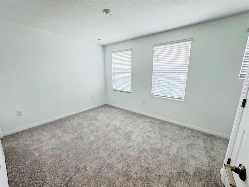 3140 Skyline Loop Kissimmee, FL 34758 - Photo 6 of 27 an empty room with windows