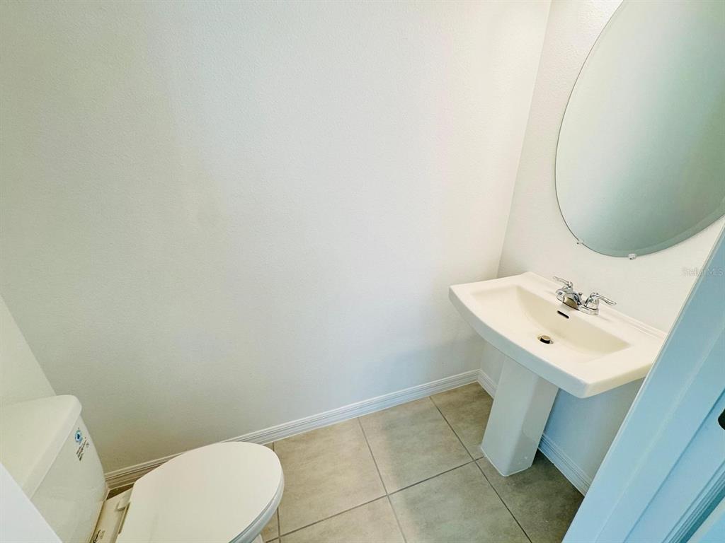 3140 Skyline Loop Kissimmee, FL 34758 - Photo 7 of 27 a bathroom with a sink mirror and toilet