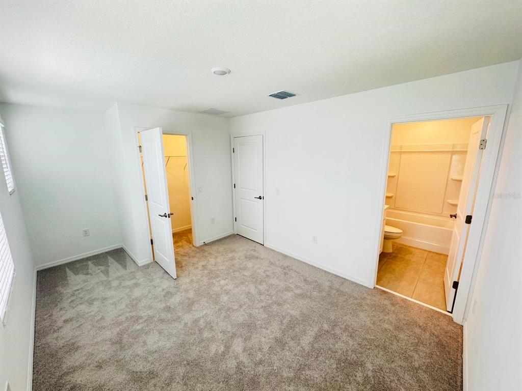 3140 Skyline Loop Kissimmee, FL 34758 - Photo 8 of 27 an empty room with a door