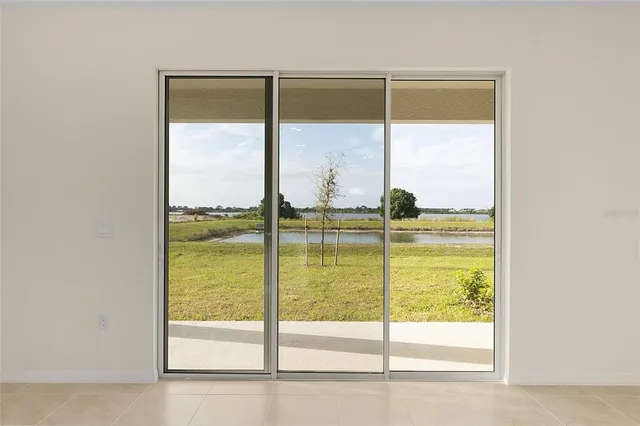 a view of a glass door with a lake view