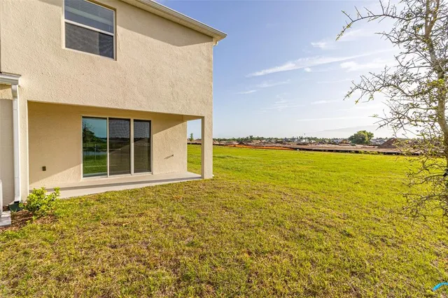 a view of a large pool with an outdoor space and seating area