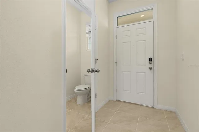 a bathroom with a granite countertop toilet and a shower