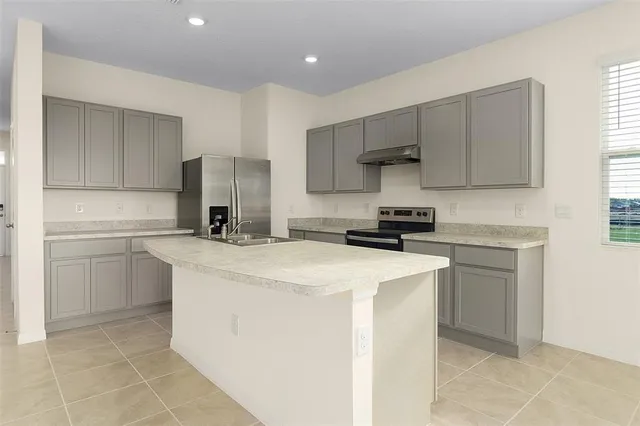 a kitchen with a sink cabinets and appliances