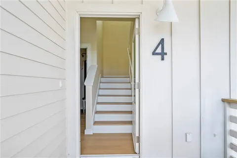 a view of a hallway with a white door and a window