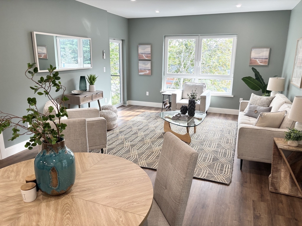 1391 Main Street, Unit 301 Walpole, MA 02081 - Photo 10 of 22 a living room with furniture and a large window