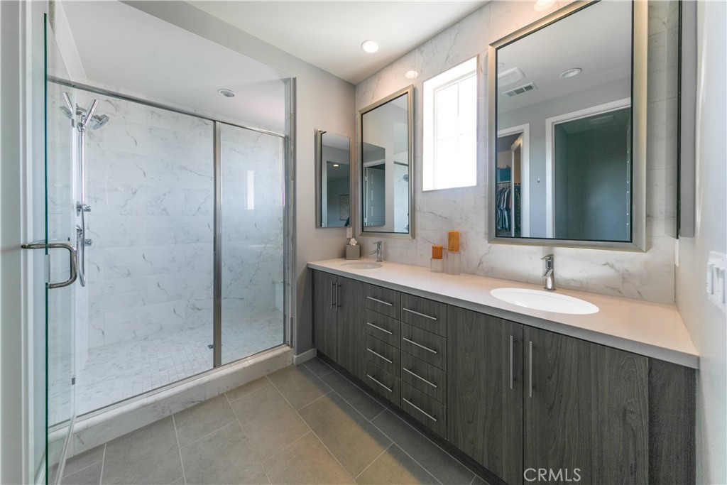 308 Finch Lake Forest, CA 92630 - Photo 15 of 35 a bathroom with a double vanity sink mirror and shower