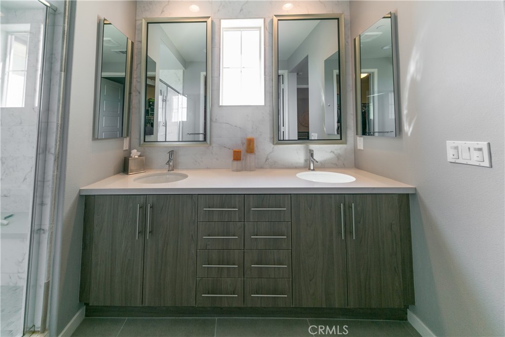 308 Finch Lake Forest, CA 92630 - Photo 16 of 35 a bathroom with a double vanity sink and a mirror