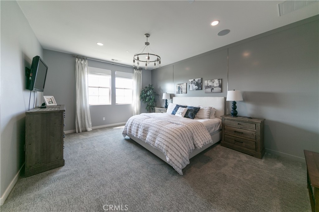 308 Finch Lake Forest, CA 92630 - Photo 18 of 35 a spacious bedroom with a bed and a flat screen television