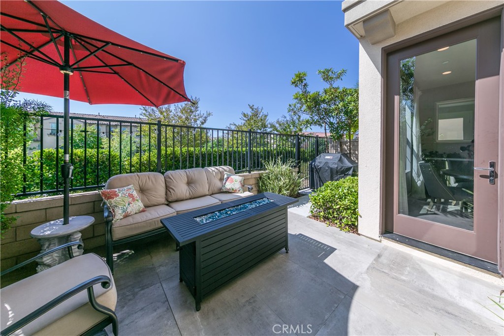 308 Finch Lake Forest, CA 92630 - Photo 22 of 35 a view of a patio with couches table and chairs under an umbrella