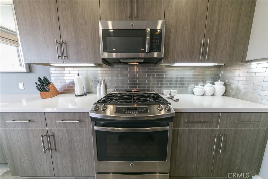 308 Finch Lake Forest, CA 92630 - Photo 7 of 35 a kitchen with granite countertop a stove top oven microwave and cabinets