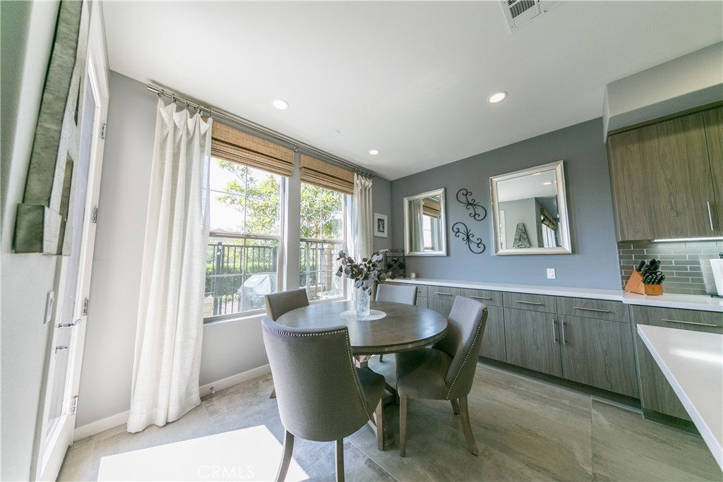 308 Finch Lake Forest, CA 92630 - Photo 9 of 35 a view of a dining room with furniture a couch and wooden floor
