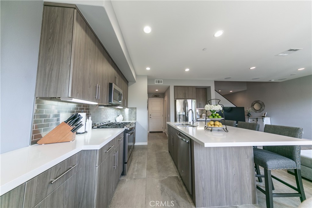 308 Finch Lake Forest, CA 92630 - Photo 10 of 35 a kitchen with a sink a stove and cabinets