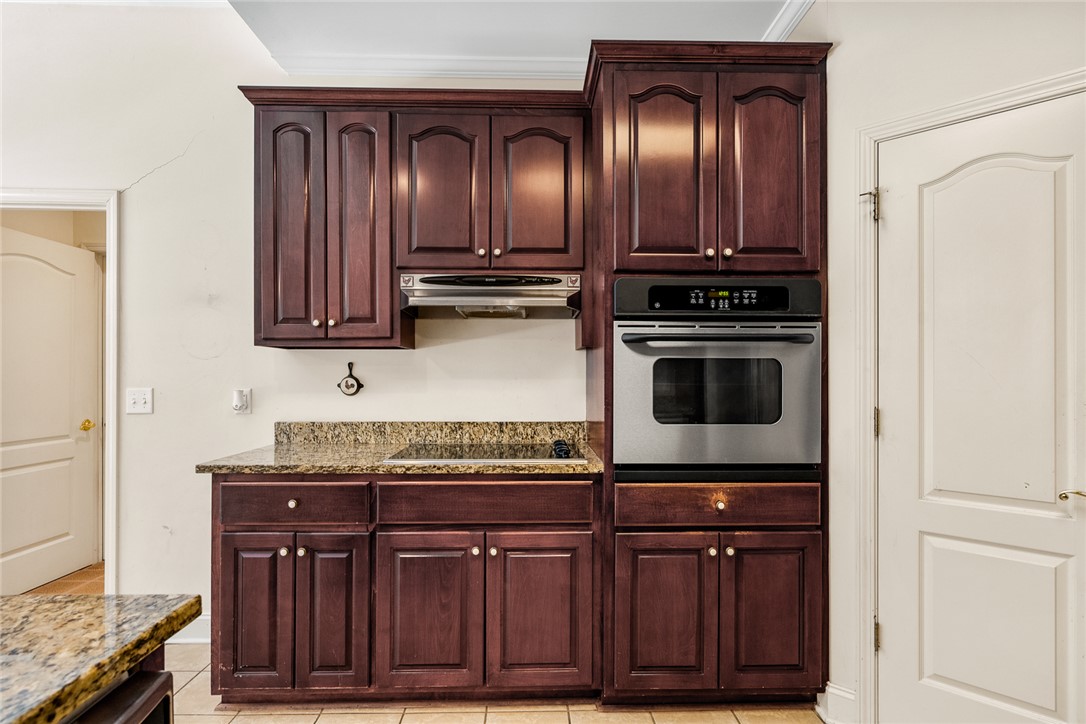 135 Sunset Bay Boulevard Seneca, SC 29672 - Photo 18 of 50 Rich wood cabinetry complements granite counters in this well-appointed kitchen.