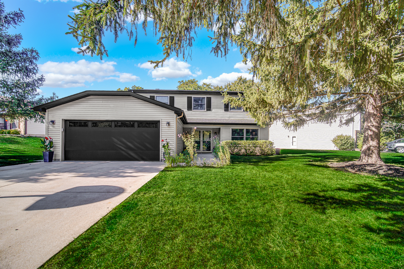1028 West Park Pl Drive Bartlett, IL 60103 - Photo 1 of 24 a front view of a house with garden