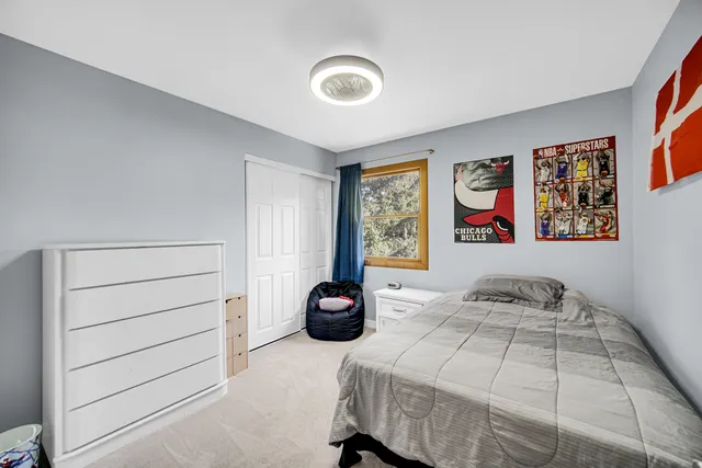 a bedroom with a bed and wall painting on the wall