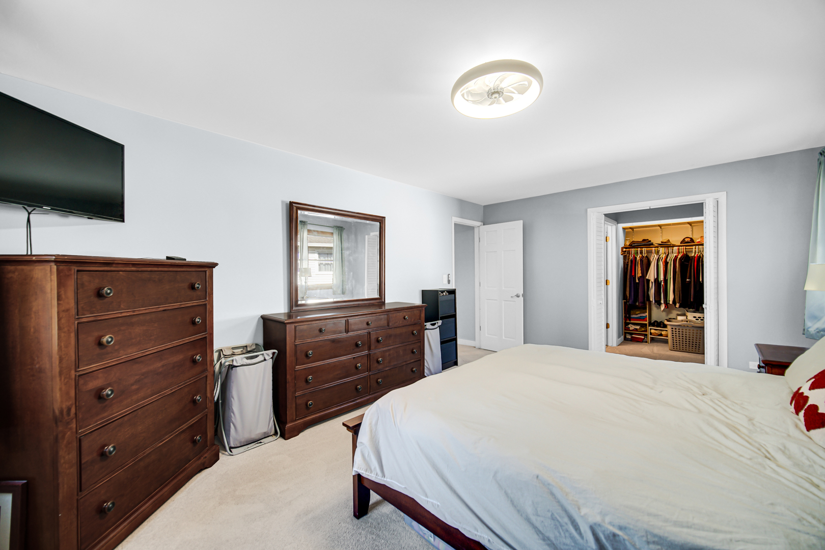 1028 West Park Pl Drive Bartlett, IL 60103 - Photo 19 of 24 a bedroom with a bed and a flat tv screen on dresser