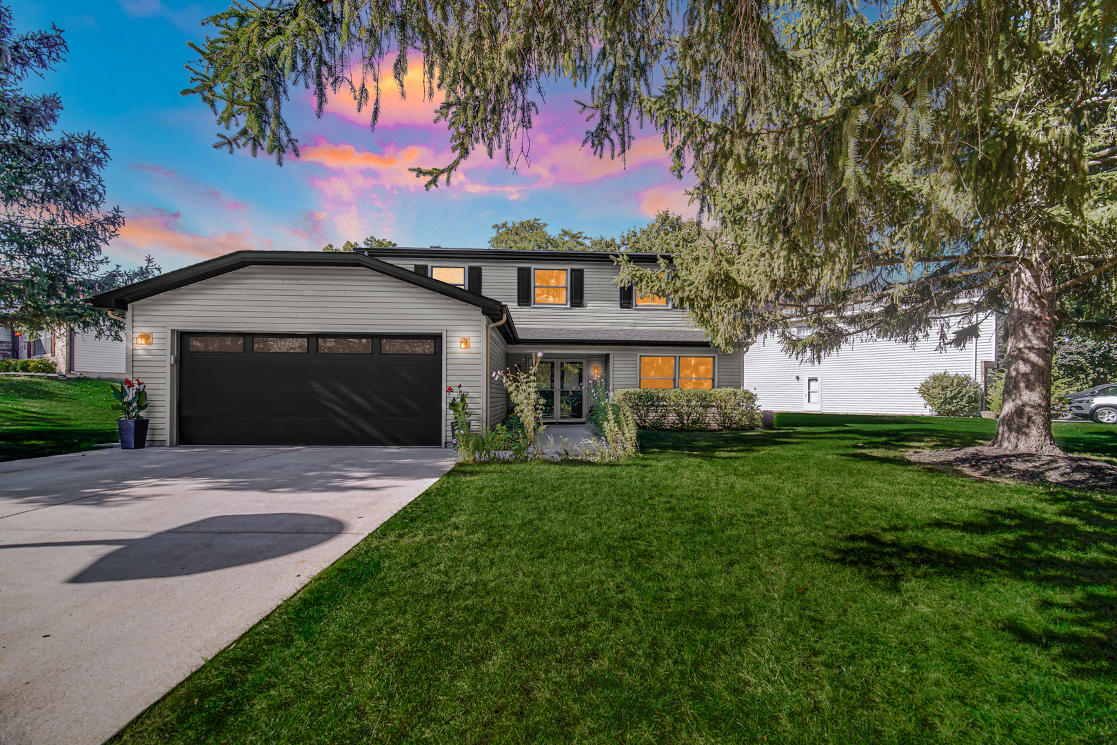 1028 West Park Pl Drive Bartlett, IL 60103 - Photo 2 of 24 a front view of a house with a garden and yard