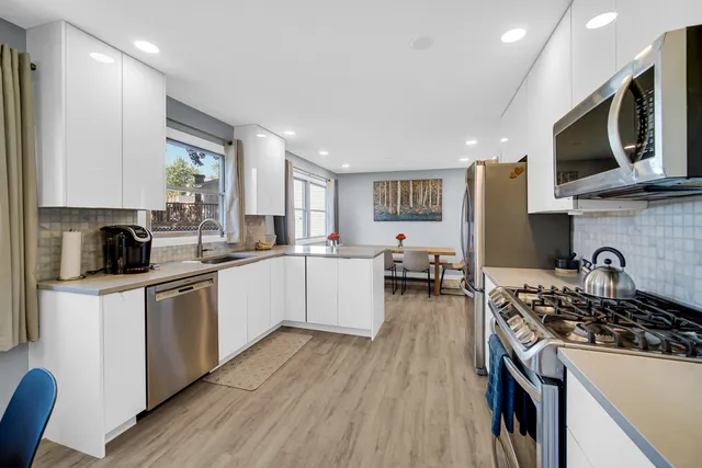 a kitchen with a stove a sink and a microwave